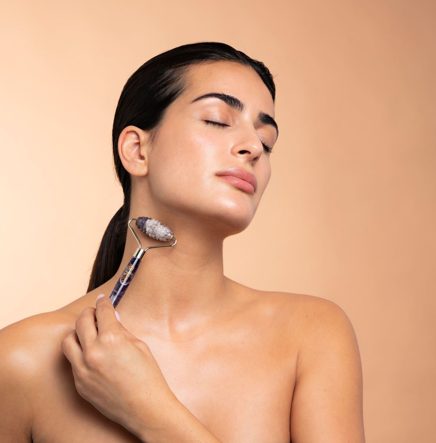 Kvinde bruger ametystrulle beauty tool